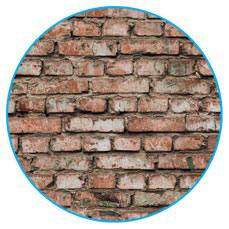 Demolished red brick wall